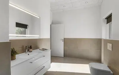 a white bathroom with a sink and a toilet at 3 Bedroom Cozy Home In Farsø in Farsø