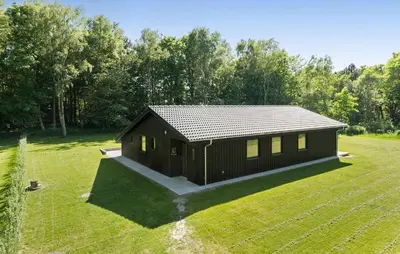 a small cabin in a field of grass at 3 Bedroom Cozy Home In Farsø in Farsø