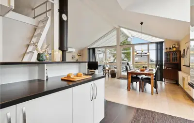 a kitchen with white cabinets and a dining room at Beautiful Home In Hurup Thy With Wifi in Doverodde