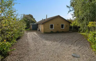 a house sitting on top of a gravel driveway at Beautiful Home In Hurup Thy With Wifi in Doverodde