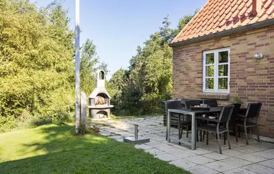 a patio with a table and a pizza oven at 3 Bedroom Amazing Home In Fur in Fur