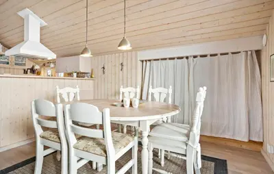 a dining room with a table and chairs at Amazing Home In Frøstrup With Sauna in Frøstrup