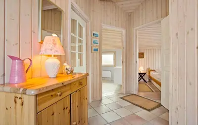 a room with a table with a lamp and a bedroom at Amazing Home In Frøstrup With Sauna in Frøstrup