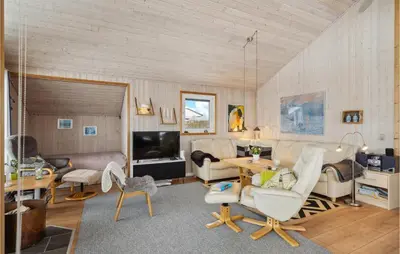 a living room with a couch and a table at Beautiful Home In Vinderup With Sauna in Vinderup
