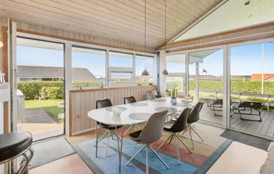 a dining room with a white table and chairs at Beautiful Home In Vinderup With Sauna in Vinderup