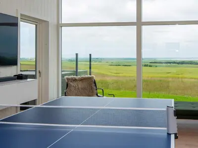 a ping pong table in a room with a window at 5 star holiday home in Lemvig-By Traum in Lemvig