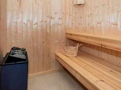 a sauna with a trash can and wooden walls at 5 star holiday home in Lemvig-By Traum in Lemvig