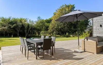 a table and chairs with an umbrella on a deck at Amazing Home In Spøttrup With Wifi in Spottrup