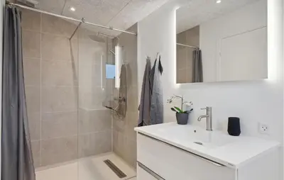 a bathroom with a shower and a sink and a mirror at Amazing Home In Spøttrup With Wifi in Spottrup