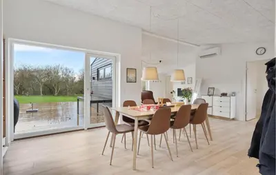 a kitchen and dining room with a table and chairs at Amazing Home In Spøttrup With Wifi in Spottrup