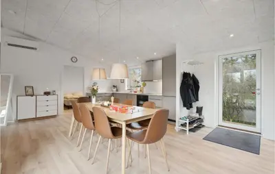 a kitchen and dining room with a table and chairs at Amazing Home In Spøttrup With Wifi in Spottrup