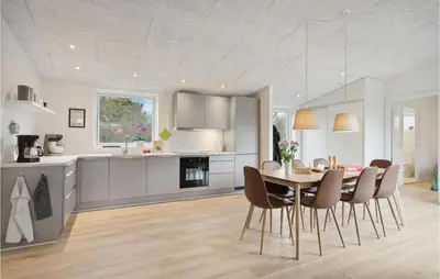 a kitchen and dining room with a table and chairs at Amazing Home In Spøttrup With Wifi in Spottrup