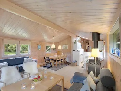a living room with a couch and a table at Holiday Home Thrineke - 600m from the sea by Interhome in Saltum
