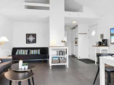 a living room with a couch and a table at Apartment Helemine - 400m from the sea by Interhome in Fjerritslev