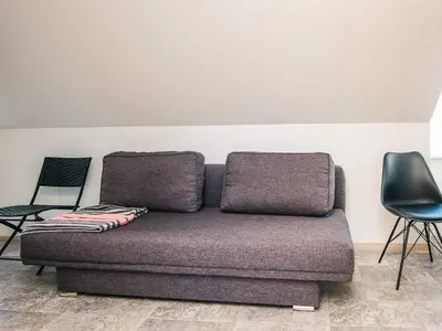 a couch sitting in a room with two chairs at 20 person holiday home in Karby-By Traum in Karby