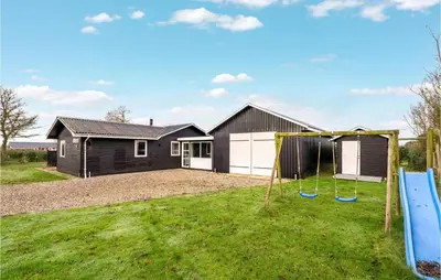 a house with a yard with a playground at 4 Bedroom Cozy Home In Vinderup in Vinderup