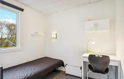 a bedroom with a bed and a desk and a chair at 4 Bedroom Cozy Home In Vinderup in Vinderup