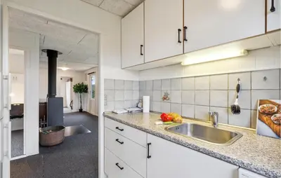 a kitchen with white cabinets and a sink at 4 Bedroom Cozy Home In Vinderup in Vinderup