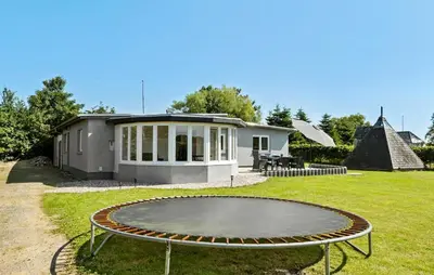 a small house with a patio and a table in the yard at Nice Home In Roslev With Wifi in Roslev