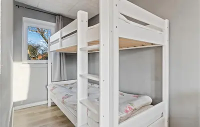 a white bunk bed in a room with a window at Nice Home In Roslev With Wifi in Roslev