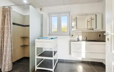 a bathroom with a sink and a shower at Nice Home In Roslev With Wifi in Roslev