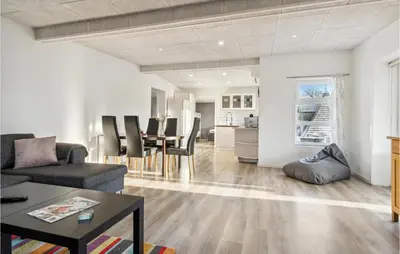 a living room with a couch and a table at Nice Home In Roslev With Wifi in Roslev