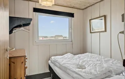 a bedroom with a bed in a room with a window at Awesome Home In Harboøre With Wifi in Harboør