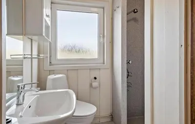 a bathroom with a sink and a toilet and a window at Awesome Home In Harboøre With Wifi in Harboør