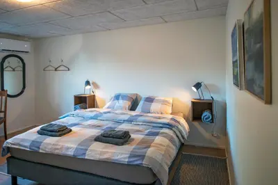 a bedroom with a bed with two towels on it at Cosy One Villa in Struer