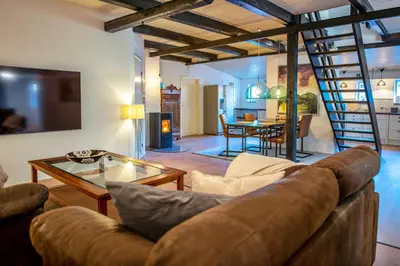 a living room with a couch and a table at Cosy One Villa in Struer