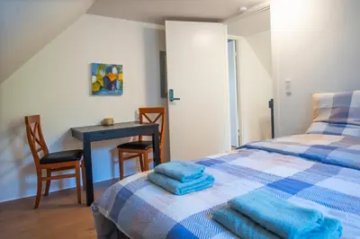 a bedroom with a bed and a table and chairs at Cosy One Villa in Struer
