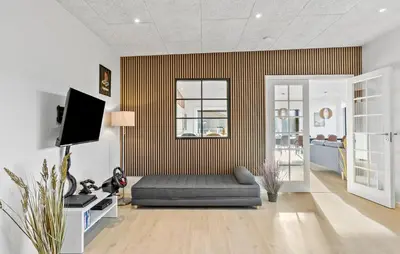 a living room with a couch and a tv at Amazing Home In Blokhus With Sauna in Blokhus