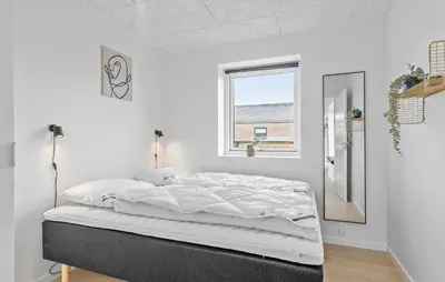 a white bedroom with a bed and a window at Amazing Home In Blokhus With Sauna in Blokhus