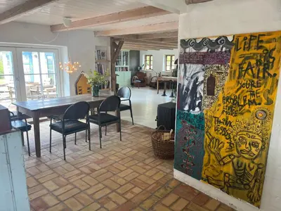 a dining room with a table and chairs in it at The Fishermen's House - charming and close to beach in Vang