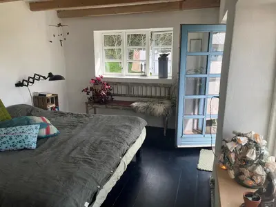 a bedroom with two beds and a window at The Fishermen's House - charming and close to beach in Vang
