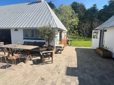 a patio with a picnic table and a building at The Fishermen's House - charming and close to beach in Vang