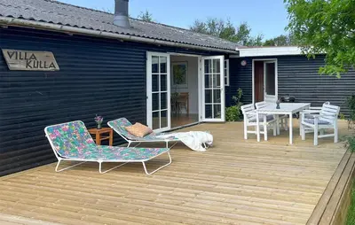 a deck with chairs and a table and a table and chairs at 3 Bedroom Gorgeous Home In Vinderup in Vinderup