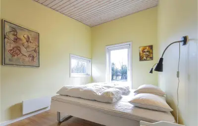 a bed sitting on a table in a room with a window at Holiday Home Vestervig 44 in Vestervig