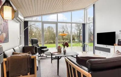 a living room filled with furniture and a large window at Holiday Home Vestervig 44 in Vestervig