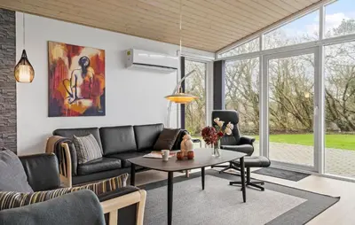 a living room with a couch and a table at Holiday Home Vestervig 44 in Vestervig