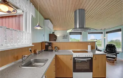 a kitchen with a sink and a stove at Holiday Home Vinderup 5 in Vinderup