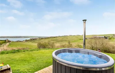 a jacuzzi tub on a deck in a yard at Holiday Home Lemvig 12 in Lemvig