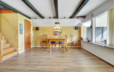 a dining room with a table and chairs at Holiday Home Thyholm 12 in Thyholm