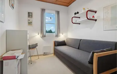 a living room with a couch and a window at Pet Friendly Apartment In Vestervig in Vestervig