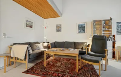 a living room with a couch and a table and chairs at Pet Friendly Apartment In Vestervig in Vestervig