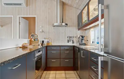 a kitchen with gray cabinets and a counter top at Awesome Home In Saltum With Kitchen in Saltum