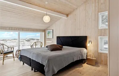 a bedroom with a bed and a table and chairs at Awesome Home In Saltum With Kitchen in Saltum