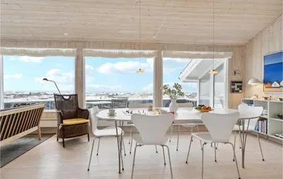 a dining room with a white table and chairs at Awesome Home In Saltum With Kitchen in Saltum