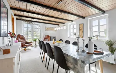 a dining room with a large table and chairs at 5 Bedroom Gorgeous Home In Thyholm in Thyholm