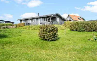 a house sitting on top of a lush green field at Amazing Home In Øster Assels With Wifi in Øster Assels